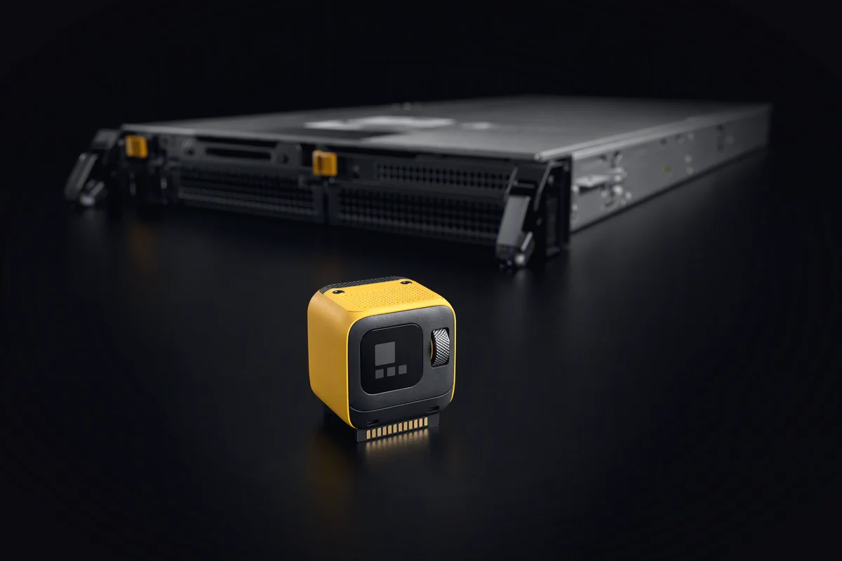 A sugar-cube-sized compute module in sharp focus in front of a large, blurred server sled